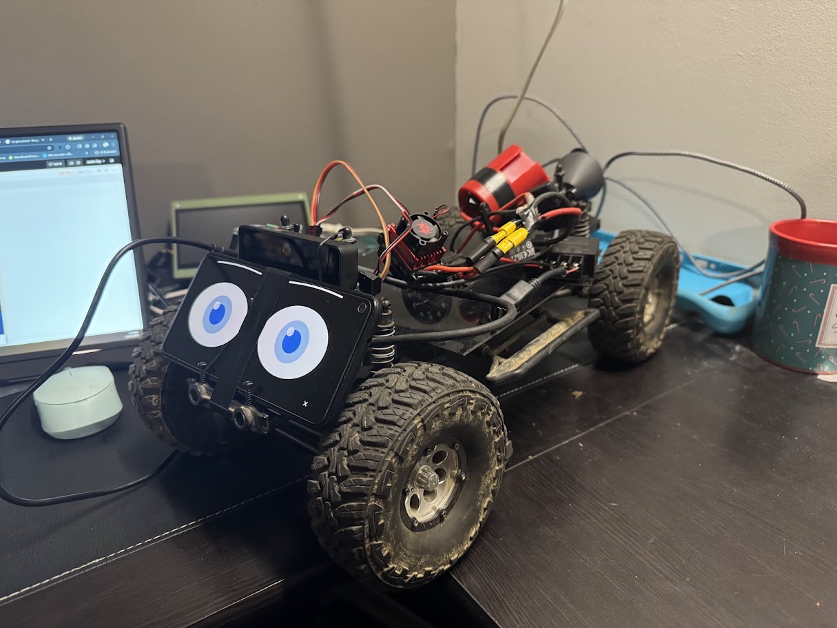 The Kilo rover with its body removed, showing the ladder chassis, drivetrain, speed controller, wiring loom and the phone head mounted at the front